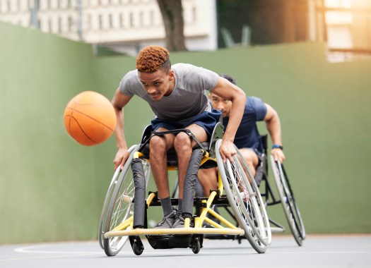 Men in wheelchairs playing wheelchair basketball
